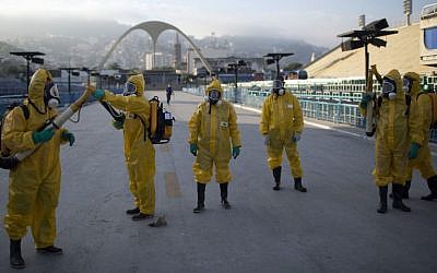 In this Tuesday, Jan. 26, 2016 file photo, health workers get ready to spray insecticide to combat the Aedes aegypti mosquitoes that transmits the Zika virus, under the bleachers of the Sambadrome in Rio de Janeiro, used for the Archery competition in the 2016 summer games. (AP/Leo Correa, File)