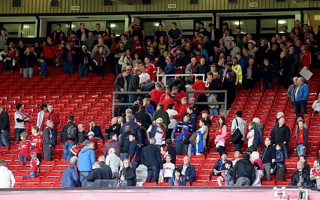 Fans and players leave the pitch and North and West stands after an announcement to evacuate before the English Premier League match at Old Trafford, Manchester, England. The match was later abandoned after a suspect package was found in the stadium. Sunday May 15, 2016. Martin Rickett/PA via AP) Fans and players leave the pitch and North and West stands after an announcement to evacuate before the English Premier League match at Old Trafford, Manchester, England. The match was later abandoned after a suspect package was found in the stadium. Sunday May 15, 2016. Martin Rickett/PA via AP)