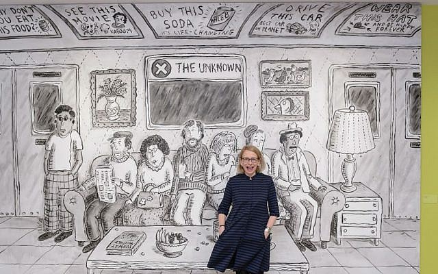 Cartoonist Roz Chast stands in front of a mural that greets visitors to her new exhibit, 'Roz Chast: Cartoon Memoirs, currently at The City Museum of New York and co-presented with the Norman Rockwell Museum. (Filip Wolak/Courtesy MCNY)