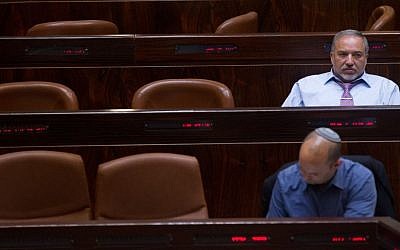Yisrael Beytenu party leader Avigdor Liberman (back) and Jewish Home party leader Naftali Bennett (front) seen during a Knesset session on May 11, 2015. (Miriam Alster/Flash90)