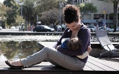 An illustrative photo of a woman breastfeeding her baby. (Tomer Neuberg/Flash90)