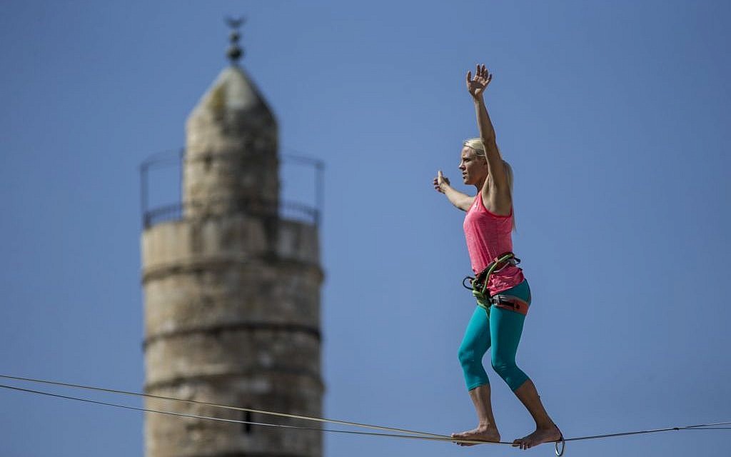 Slackliner Heather Larsen makes her way between two ancient citadels at Jerusalem's Tower of David Museum on May 2, 2016 (Yonatan Sindel/Flash90)