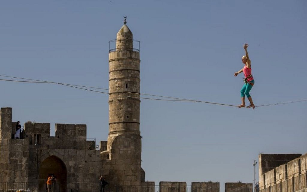 Slackliner Heather Larsen makes her way between two ancient citadels at Jerusalem's Tower of David Museum on May 2, 2016 (Yonatan Sindel/Flash90)