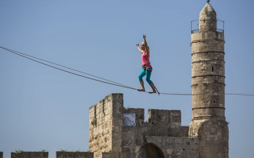 Slackliner Heather Larsen makes her way between two ancient citadels at Jerusalem's Tower of David Museum on May 2, 2016 (Yonatan Sindel/Flash90)