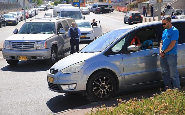 People stand still after pulling over on a road in Jerusalem, as a two-minute siren is sounded across Israel to mark Holocaust Remembrance Day on May 5, 2016. (Nati Shohat/Flash90) People stand still after pulling over on a road in Jerusalem, as a two-minute siren is sounded across Israel to mark Holocaust Remembrance Day on May 5, 2016. (Nati Shohat/Flash90)