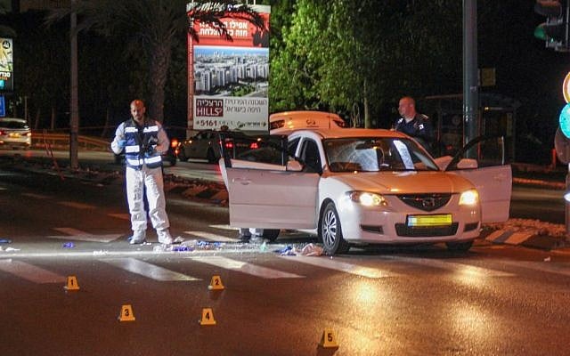 A forensic team examines the scene where Shai Shirazi, 30 was shot dead and another person wounded after a gunman opened fire on their car in Tel Aviv, May 7, 2016. (Moti Karelitz/Flash90) 