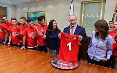 Prime Minister Benjamin Netanyahu and Culture and Sports Minister Miri Regev meet with Hapoel Beersheba F.C. soccer players and staff members in celebration of their winning the Israeli league championship, at the Prime Minister's Office in Jerusalem, May 24, 2016. (Kobi Gideon/GPO)