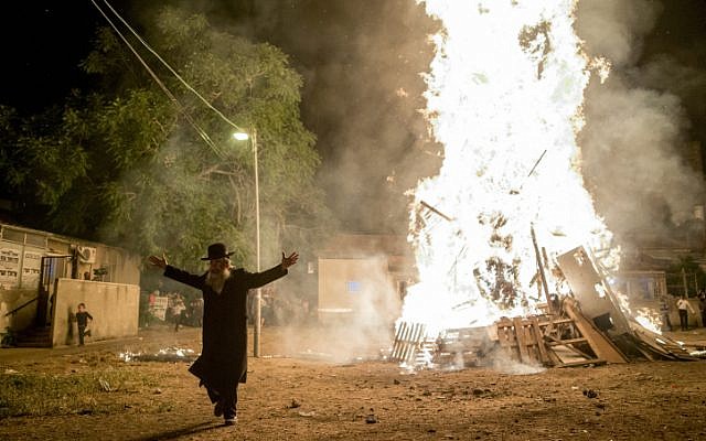 Ultra-Orthodox Jews seen near a big bonfire, during celebrations of the Jewish holiday of Lag Ba'Omer in neighborhood of Mea Shearim in Jerusalem on May 25, 2016.(Yonatan Sindel/Flash90)