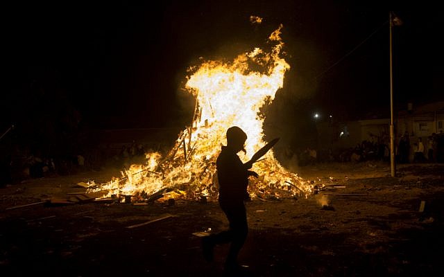 Ultra-Orthodox Jews seen near a big bonfire, during celebrations of the Jewish holiday of Lag Ba'Omer in the eighborhood of Mea Shearim in Jerusalem on May 25, 2016. (Yonatan Sindel/Flash90 )