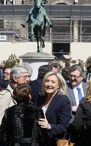 France's far-right National Front party leader Marine Le Pen stands in front of the statue of Joan of Arc, during the party's traditional May Day demonstration in Paris, France, Sunday, May 1, 2016. (AP/Michel Spingler)