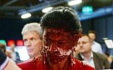 Germany's main opposition leader Sahra Wgenknecht has her face covered with cream after activists threw a cake at her during a party congress in Magdeburg, Germany, Saturday, May 28, 2016. (Hendrik Schmidt/dpa via AP)