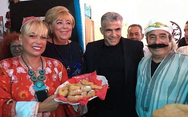 Yesh Atid leader Yair Lapid (Second R) attends a Mimouna event in Netanya on April 30, 2016 (Yesh Atid spokesperson/courtesy)
