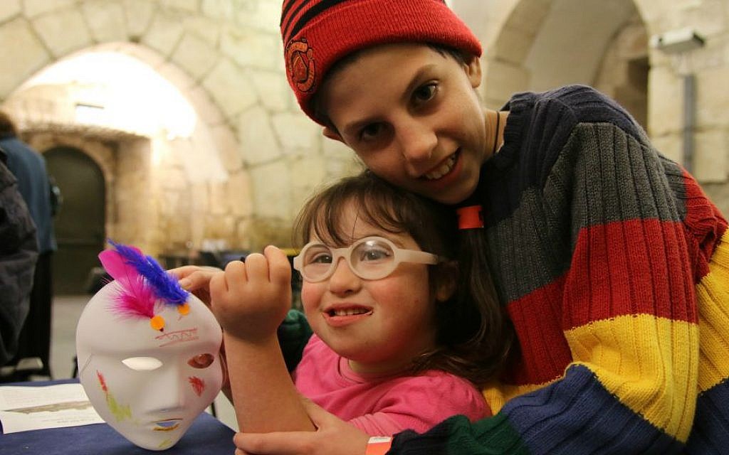 A brother hugs his sister at Tower of David Museum's Purim program for families with children with special needs, March 2016 (Ricky Rachman) A brother hugs his sister at Tower of David Museum's Purim program for families with children with special needs, March 2016 (Ricky Rachman)