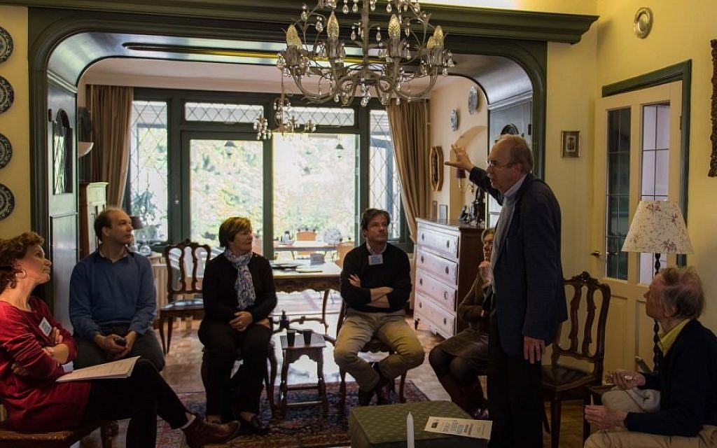 Kees van den Heuvel, standing, talking to guests about the Jewish family that once lived in what is now his home in the Netherlands town of Vught, April 30, 2016. (Cnaan Liphshiz) Kees van den Heuvel, standing, talking to guests about the Jewish family that once lived in what is now his home in the Netherlands town of Vught, April 30, 2016. (Cnaan Liphshiz)