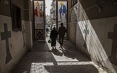 Coptic Christians walk outside St. Markos Church in Minya, south of Cairo, Egypt, January 2015. (AP Photo/Roger Anis)