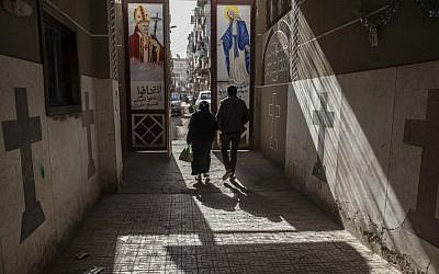 Coptic Christians walk outside St. Markos Church in Minya, south of Cairo, Egypt, January 2015. (AP Photo/Roger Anis)
