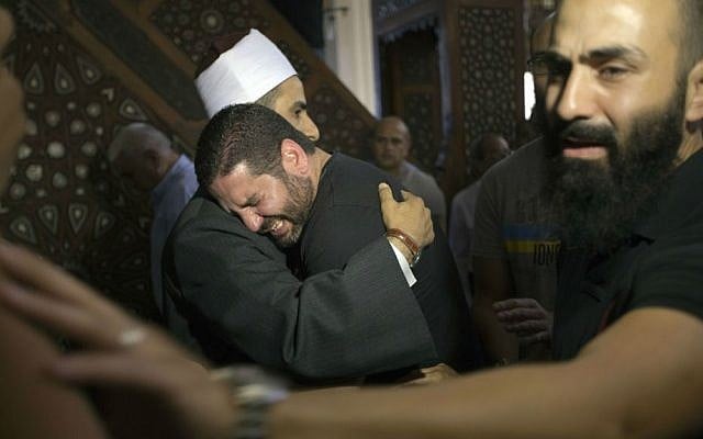 The Imam of Cairo's al Thawrah Mosque, Samir Abdel Bary, consoles Tarek Abu Laban, center, who lost four relatives in Thursday's EgyptAir plane crash, at a prayer gathering for the dead at al Thawrah Mosque, Friday, May 20, 2016. (AP Photo/Amr Nabil) The Imam of Cairo's al Thawrah Mosque, Samir Abdel Bary, consoles Tarek Abu Laban, center, who lost four relatives in Thursday's EgyptAir plane crash, at a prayer gathering for the dead at al Thawrah Mosque, Friday, May 20, 2016. (AP Photo/Amr Nabil)