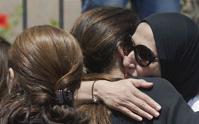 Relatives and friends of Salah Abu Laban, Sahar Qouidar, Ghassan Abu Laban and Reem al-Sebaei, all victims of EgyptAir flight 804, which crashed while carrying 66 passengers and crew from Paris to Cairo, grieve following prayers for the dead at Cairo's al Thawrah Mosque, Friday, May 20, 2016. (AP Photo/Amr Nabil)