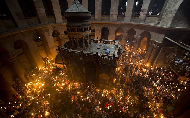 Christian Orthodox pilgrims hold candles during Holy Fire ceremony in the church of the Holy Sepulchre, traditionally believed to be the burial site of Jesus Christ, Saturday, April 30, 2016 in Jerusalem. (AP Photo/Dusan Vranic)