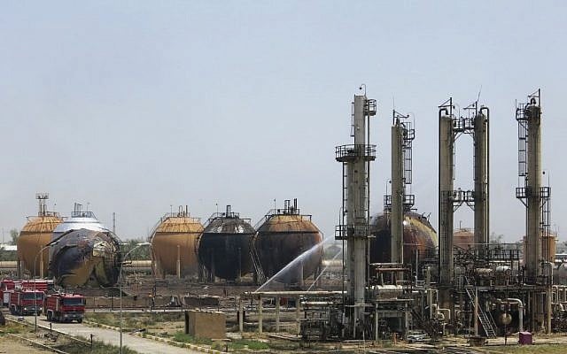 Iraqi firefighters try to extinguish a fire at a natural gas plant in Taji, 20 kilometers (12 miles) north of Baghdad, Iraq, May 15, 2016. (AP)