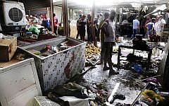 Citizens inspect the scene after a bomb explosion at outdoor market in Baghdad's northern neighborhood of Shaab, Iraq, May 17, 2016. (AP/Khalid Mohammed)