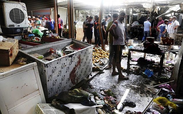 Citizens inspect the scene after a bomb explosion at outdoor market in Baghdad's northern neighborhood of Shaab, Iraq, May 17, 2016. (AP/Khalid Mohammed) Citizens inspect the scene after a bomb explosion at outdoor market in Baghdad's northern neighborhood of Shaab, Iraq, May 17, 2016. (AP/Khalid Mohammed)