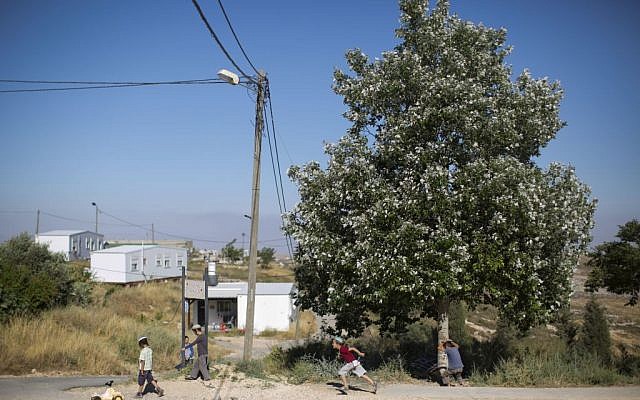 In this Wednesday, May 18, 2016 photo, Jewish settler children play next to a road in Amona, an Israeli outpost in the West Bank, east of the Palestinian city of Ramallah. (AP Photo/Oded Balilty)