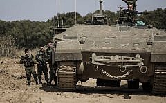 Illustrative: Israeli soldiers stand by an armored personnel carrier near the Israel Gaza border, May 4, 2016. (AP photo/Tsafrir Abayov)