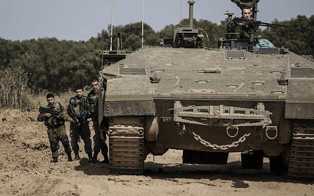 Israeli soldiers stand by an armored personnel carrier near the Israel Gaza border, Wednesday, May 4, 2016. (AP photo/Tsafrir Abayov) Israeli soldiers stand by an armored personnel carrier near the Israel Gaza border, Wednesday, May 4, 2016. (AP photo/Tsafrir Abayov)