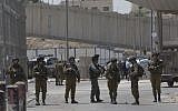 Israeli security forces at the main entrance of the Qalandiya checkpoint, a key crossing point between Jerusalem and the West Bank city of Ramallah, April 27, 2016. (AP Photo/Nasser Nasser)