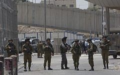 Israeli security forces at the main entrance of the Qalandiya checkpoint, a key crossing point between Jerusalem and the West Bank city of Ramallah, April 27, 2016. (AP Photo/Nasser Nasser)