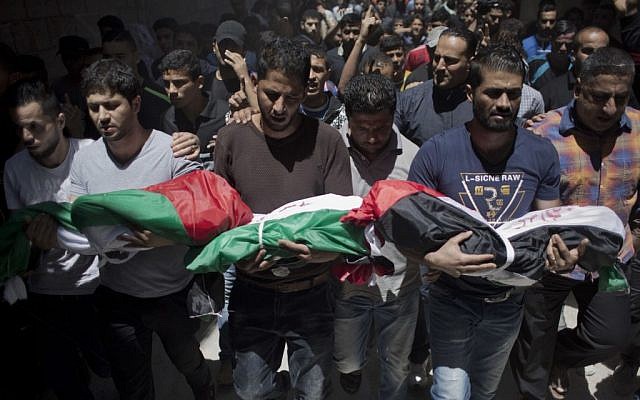 Palestinian mourners carry the bodies of three children who were killed in a fire caused by a candle, during their funeral in the Shati refugee camp in Gaza City, Saturday, May 7, 2016. (AP Photo/ Khalil Hamra) Palestinian mourners carry the bodies of three children who were killed in a fire caused by a candle, during their funeral in the Shati refugee camp in Gaza City, Saturday, May 7, 2016. (AP Photo/ Khalil Hamra)