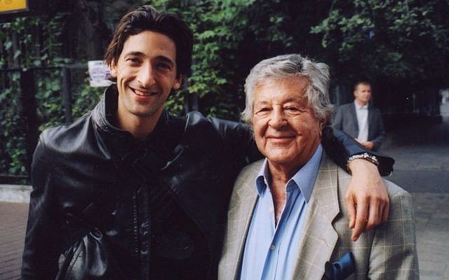 In this 2000 photo, film producer Gene Gutowski, right, poses with actor Adrien Brody during the production of the Oscar-winning Holocaust film “The Pianist.” (AP Photo/Adam Bardach)