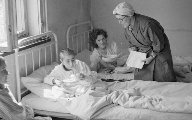 A British social worker treats survivors of the Bergen-Belsen concentration camp soon after liberation (Imperial War Museum) A British social worker treats survivors of the Bergen-Belsen concentration camp soon after liberation (Imperial War Museum)