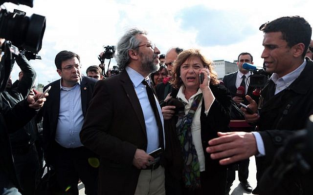 Journalist Can Dundar, center, and his wife Dilek look on just after the attack on Can Dundar outside city's main courthouse in Istanbul, Friday, May 6, 2016. (Can Erok, Cumhuriyet via AP) Journalist Can Dundar, center, and his wife Dilek look on just after the attack on Can Dundar outside city's main courthouse in Istanbul, Friday, May 6, 2016. (Can Erok, Cumhuriyet via AP)