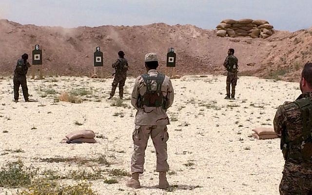 Syrian Arab trainees practice firing their small arms at an undisclosed training range in northern Syria on Saturday, May 21, 2016. (AP Photo/Robert Burns)
