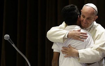 Pope Francis holds a migrant child during a meeting with some 400 children coming by train from the region of Calabria, at the Vatican, Saturday, May 28, 2016. (AP Photos/Gregorio Borgia, Pool)