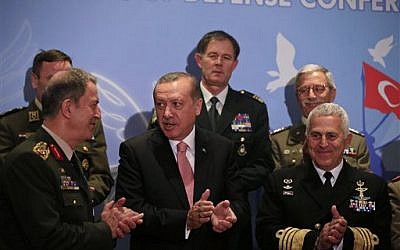 Turkey's President Recep Tayyip Erdogan, center, talks with Turkey's Chief of Staff Gen. Hulusi Akar, left, as he poses for photographs with military chiefs of Balkan nations following his speech at their conference, in Istanbul Wednesday, May 11, 2016. (AP Photo/Lefteris Pitarakis)