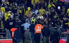 Fans of the Beitar Jerusalem soccer club fighting with police in the stands at Jerusalem's Teddy Stadium on May 1, 2016. (screen capture: YouTube/ONE)