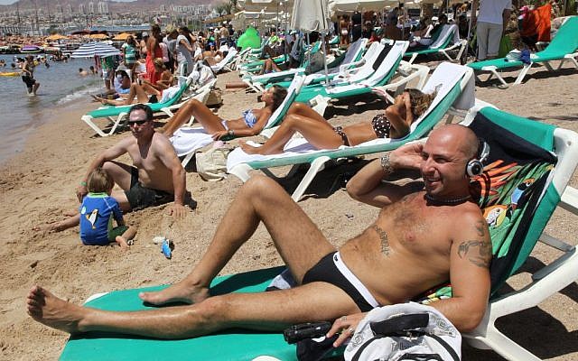 Illustrative photo of Israelis relaxing on the beach in the southern city of Eilat. (Nati Shohat/Flash90)