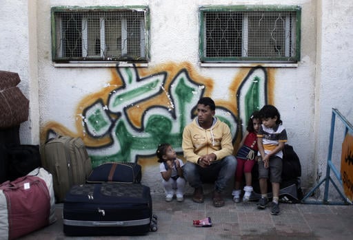 A Palestinian family sit next to their luggage as they wait for their turn to enter the Rafah border crossing with Egypt, in the southern Gaza Strip, May 11, 2016. (AP Photo/ Khalil Hamra) A Palestinian family sit next to their luggage as they wait for their turn to enter the Rafah border crossing with Egypt, in the southern Gaza Strip, May 11, 2016. (AP Photo/ Khalil Hamra)