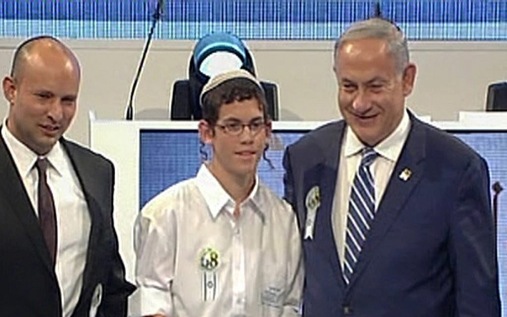Elkana Friedman, the winner of the annual International Bible Contest, stands with Education Minister Naftali Bennett and Prime Minister Benjamin Netanyahu, on May 12, 2016 (screen capture: Channel 1)