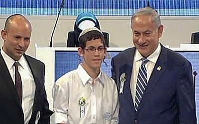 Elkana Friedman, the winner of the annual International Bible Contest, stands with Education Minister Naftali Bennett and Prime Minister Benjamin Netanyahu, on May 12, 2016 (screen capture: Channel 1)