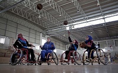 Disabled Palestinian women take part in a basketball training session with top US coach Jess Markt in the Khan Younis refugee camp, southern Gaza Strip, May 28, 2016. (AP/Khalil Hamra)