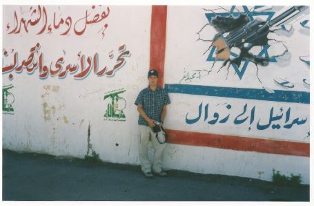 Matti Friedman, the tourist, in front of Hezbollah slogans in southern Lebanon (Courtesy Matti Friedman) Matti Friedman, the tourist, in front of Hezbollah slogans in southern Lebanon (Courtesy Matti Friedman)