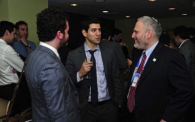 Chanan Weissman, center, speaking with Jewish Federations Washington director William Daroff, right, and Jordan Hirsch. (Ron Sachs from CNP/Courtesy of Jewish Insider)