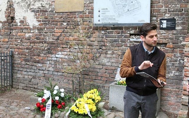 Polish tour guide Kuba Wesolowski at a surviving wall of the Warsaw ghetto. (Shmuel Bar-Am)