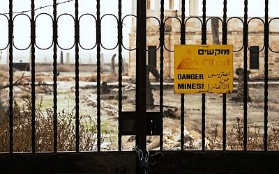 A sealed gate preventing visitors from approaching a church at Qasr al-Yahud, the Jordan River site believed by many Christians to be the site of Jesus's baptism. A sign on the gate reads "Danger mines!" in Hebrew, Arabic and English. (YouTube screen capture)