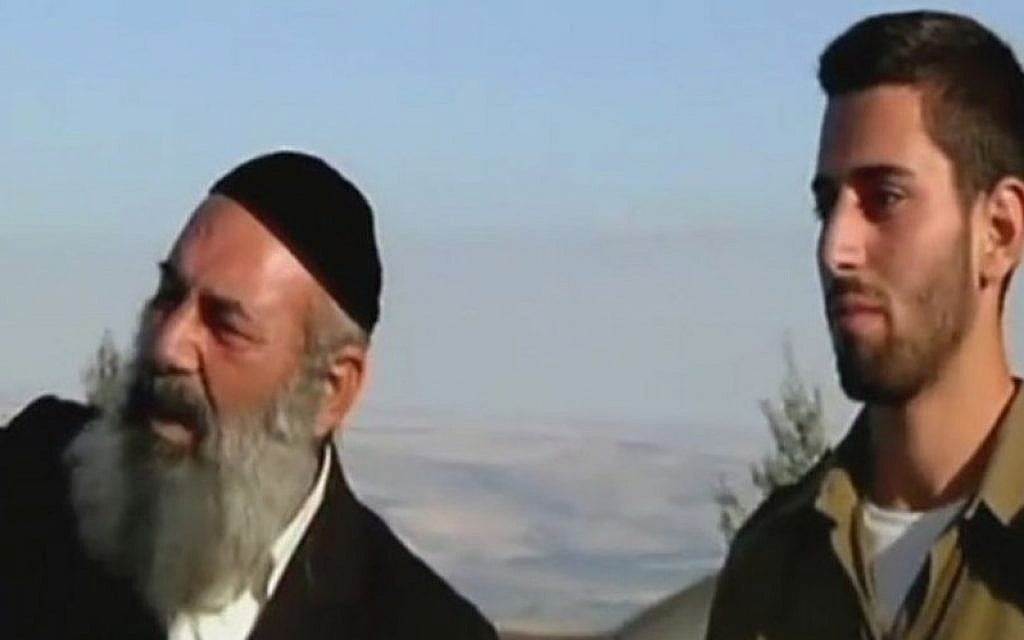 Rabbi Avraham Sinai (L) and son Amos look out at the Lebanese border (Channel 2 news) Rabbi Avraham Sinai (L) and son Amos look out at the Lebanese border (Channel 2 news)