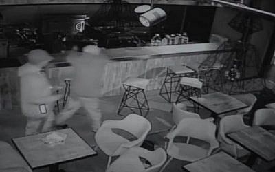 CCTV footage shows two men soaking a kosher restaurant in Manchester with fuel before setting it alight on May 6, 2016 (screen capture)
